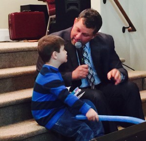Chris Reed talking with young boy who accepted Christ.